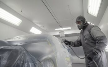 Painting one of the most difficult automotive colors using professional spray techniques, showing smooth blending, precise layers, and a flawless glossy finish in a detailed workshop environment.